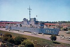 a large battleship sitting on top of a field