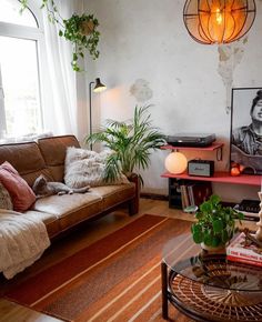 a living room filled with furniture and plants