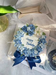 a birthday cake with blue flowers on it