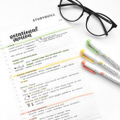 a pair of glasses sitting on top of a notebook next to some pens and paper