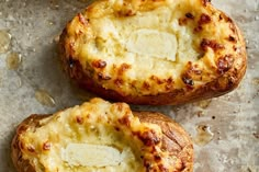 three baked potatoes sitting on top of a table