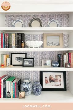 the shelves are filled with books, pictures and other things to put on top of them