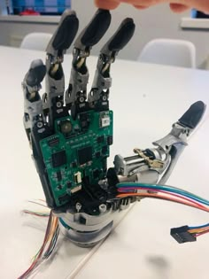 the robotic hand is connected to several wires