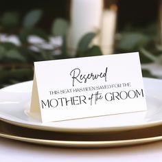 a white plate topped with a card that reads, reserved the seat has been saved for the mother of the groom