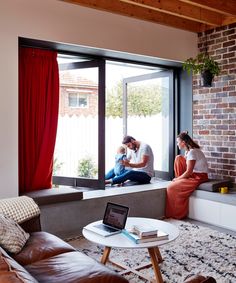 a man and woman sitting on a window sill