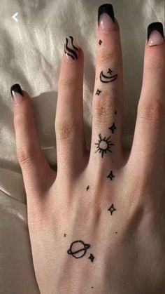 a woman's hand with some tattoos on it