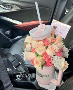 a bouquet of flowers in a car cup holder