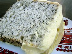 a piece of cake with white frosting and black sprinkles on it