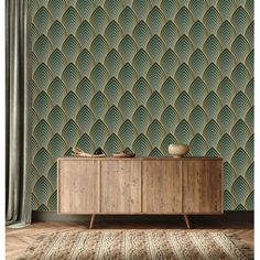 an art deco style wallpaper with green and gold scales on the sideboard, in front of a curtained window