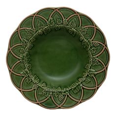 a green plate with an intricate design on the front and center, set against a white background