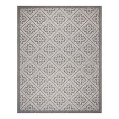 a gray and white rug with an intricate design on the bottom, in front of a white background