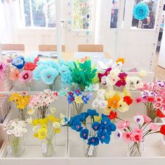 several vases filled with colorful flowers on top of a table