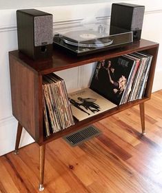 a record player is sitting on top of a shelf