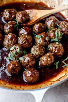 meatballs and sauce in a pot with a wooden spoon on the side, ready to be eaten