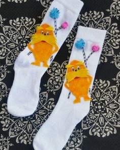 two pairs of socks with cartoon characters on them