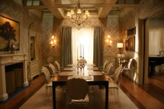 a dining room table with chairs and a chandelier