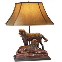 a lamp that is on top of a wooden base with a dog figurine underneath it