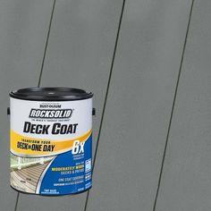 a can of rock solid deck coat sitting on top of a wooden fence