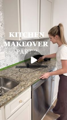 a woman standing in front of a kitchen counter with an oven and dishwasher