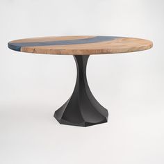 a round wooden table sitting on top of a white floor