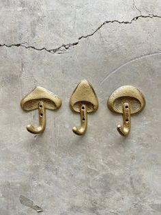 three brass door handles with mushrooms on them