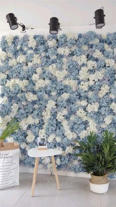 the wall is covered with blue and white flowers