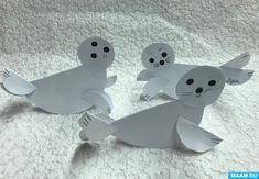 three white paper cut out of sea animals