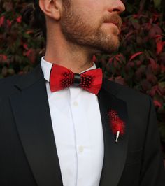 The Jaxon Feather bow tie is a classic red and black tie that will keep it sharp and your look formally fresh. It is a classic, understated, and unique groom's tie. Perfect for weddings and special events. An absolute must-have bow tie to add to your collection. This sleek red tie also comes in children's sizes so your groomsmen and ring bearer bow ties can match! Every Feather Bow Ties Comes with: Beautiful, Hand-Crafted, High Quality Feather Bow Tie, with an adjustable strap that can fit up to Dapper Red Suit And Tie Accessories For Formal Events, Dapper Red Suit And Tie Accessories For Formal Occasions, Red Ties For Black-tie Events, Adjustable Red Suit And Tie Accessories For Wedding, Fitted Red Bow Tie For Black Tie Events, Elegant Red Adjustable Bow, Dapper Bow Tie For Black-tie Events, Classic Red Bow For Black Tie Events, Classic Red Bow Tie For Formal Occasions