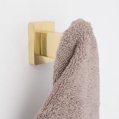 a towel hanging on the wall next to a hook