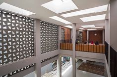 the inside of an office building with multiple floors and walls covered in decorative metal screens