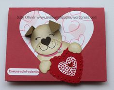 a card with a dog holding a heart