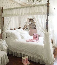 a white bed sitting in a bedroom next to a chandelier