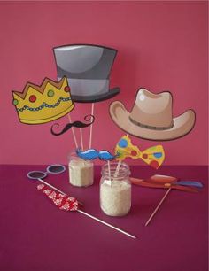 a table topped with two jars filled with candy and hats on top of each other