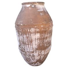 a large brown vase sitting on top of a white table