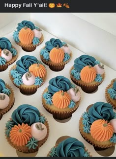 there are many cupcakes with blue and orange frosting