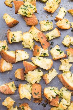 garlic herb croutons on a baking sheet with text overlay that reads garlic herb croutons