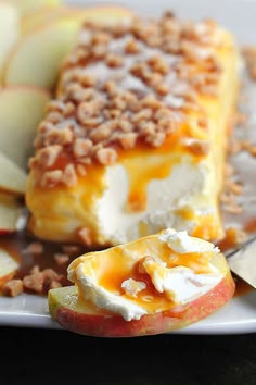 an apple dessert on a white plate with apples