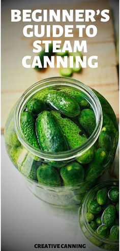 a jar filled with green cucumbers sitting on top of a wooden table next to another