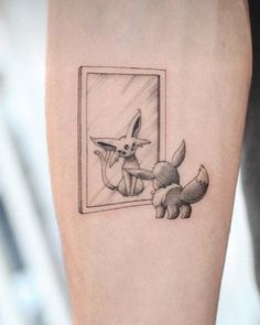 a small tattoo on the leg of a person with a mirror and a fox in it