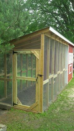 a chicken coop in the middle of a field