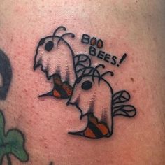 a close up of a person's leg with tattoos on it and the words boo bees