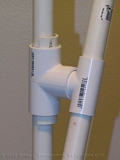 two white pipes connected to each other with barcodes on the top and bottom