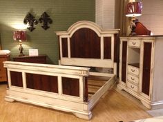 a bed and dresser in a room with hard wood floors