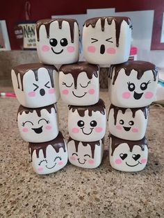 chocolate covered marshmallows with faces on them sitting on top of a counter