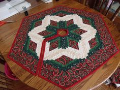 a quilted table topper sitting on top of a wooden table