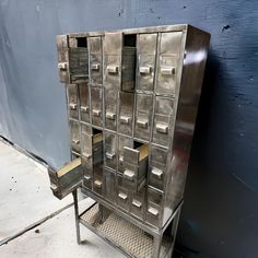 a metal filing cabinet sitting next to a blue wall