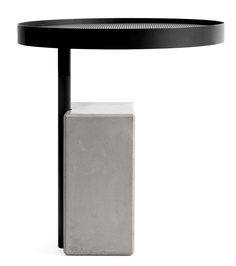 a black table with a white square on it and a grey block underneath the table