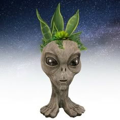 an alien head with plants growing out of it's face and stars in the background