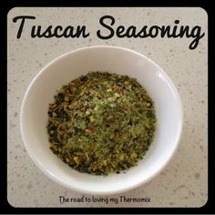 a white bowl filled with green seasoning on top of a marble counter next to the words tuscann seasoning