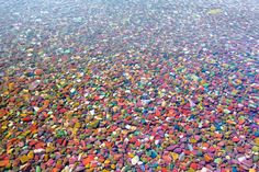 an aerial view of colorful rocks on the ground